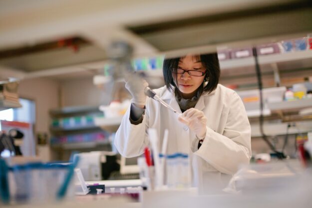 A scientist carefully conducts her experiment in a research laboratory