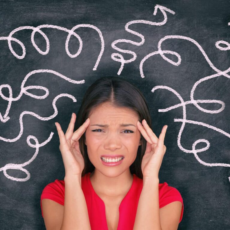 Confused woman confusion illustrated on blackboard with chalk drawing of arrows going everywhere around head showing indecision. Indecisive stressed Asian girl with headache panoramic banner.