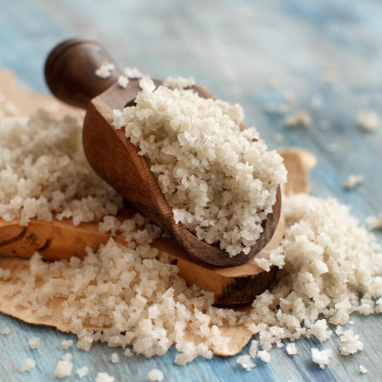 Celtic Grey Sea Salt with a spoon on a blue wooden table