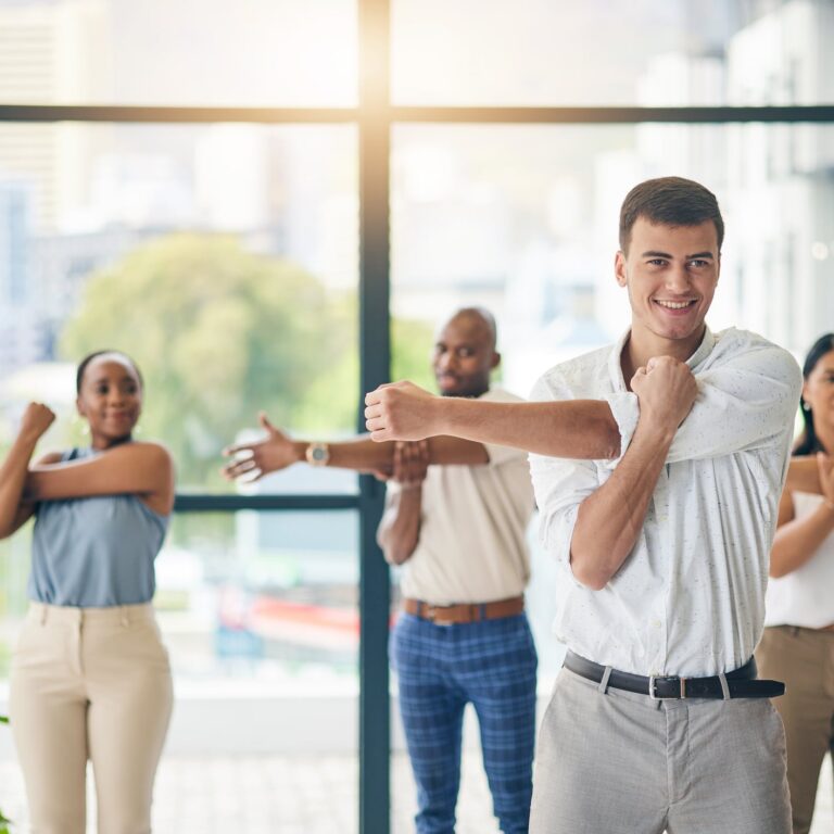 Workout, stretching and a group of business people in the office to exercise for health or mobility together. Fitness, wellness and coach training an employee team in the workplace for a warm up