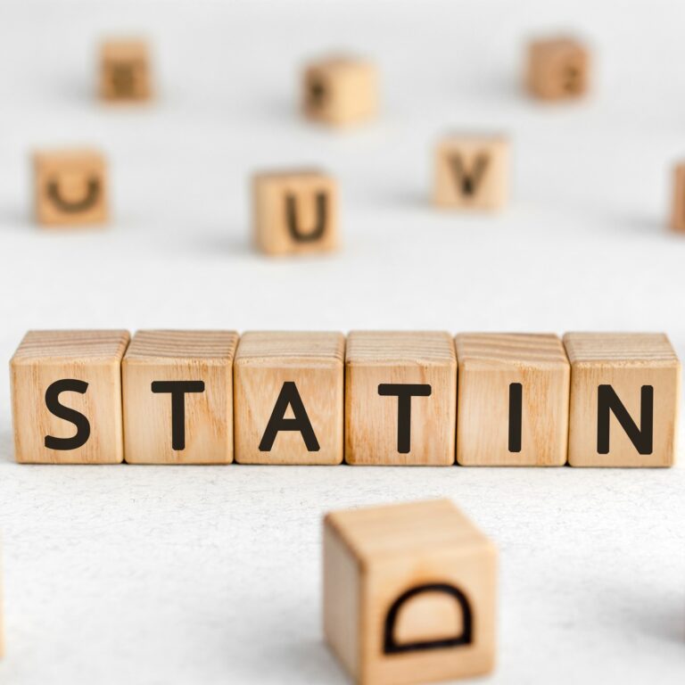 Statin - words from wooden blocks with letters, cholesterol level reduces drugs statin concept, white background