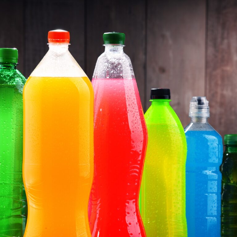 Plastic bottles of assorted carbonated soft drinks in variety of colors